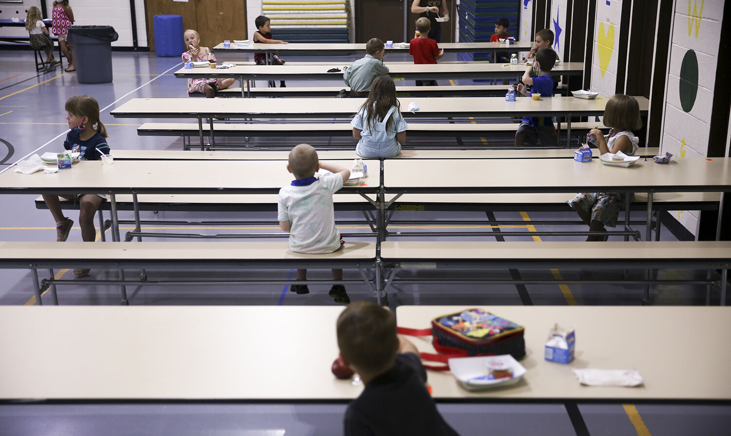 Students are spread out when they are in the cafeteria so that they an eat at a safe distance